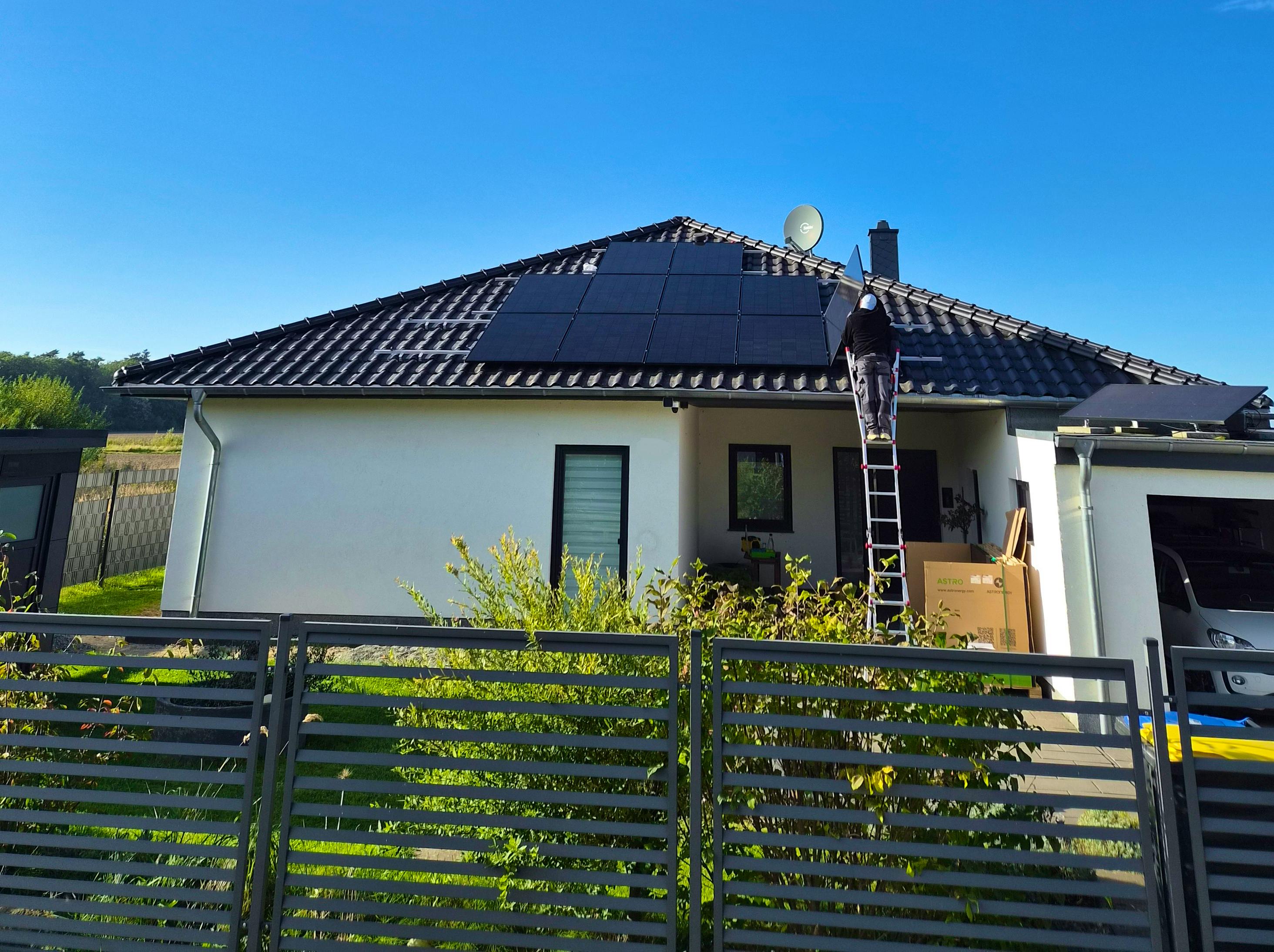 Montage der Photovoltaik-Module auf dem Walmdach des Bungalows