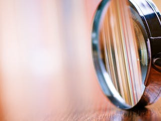 Lupe liegt aufgestellt auf Schreibtisch