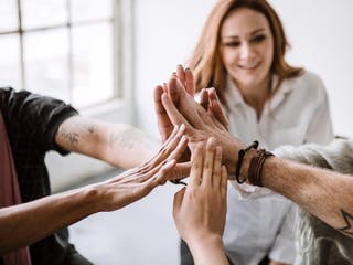 Bauherrengemeinschaft bringen die Hände in der Mitte zusammen