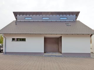 Massivhaus Freie Planung - Haus 5 von KOSIMA HAUS, Pultdachhaus Außenansicht 2