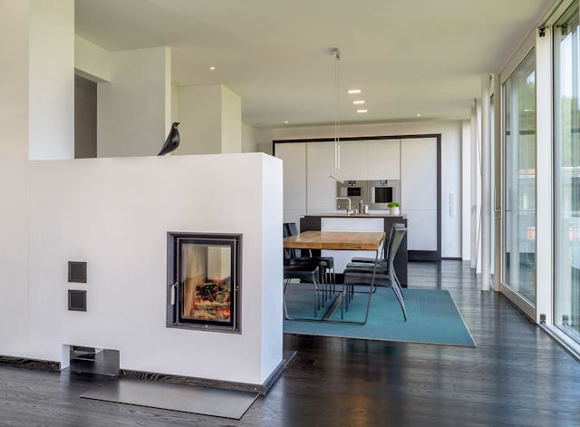 Luxus-Fertighaus-Villa von Innen: Kaminofen als Raumtrenner von Bau-Fritz