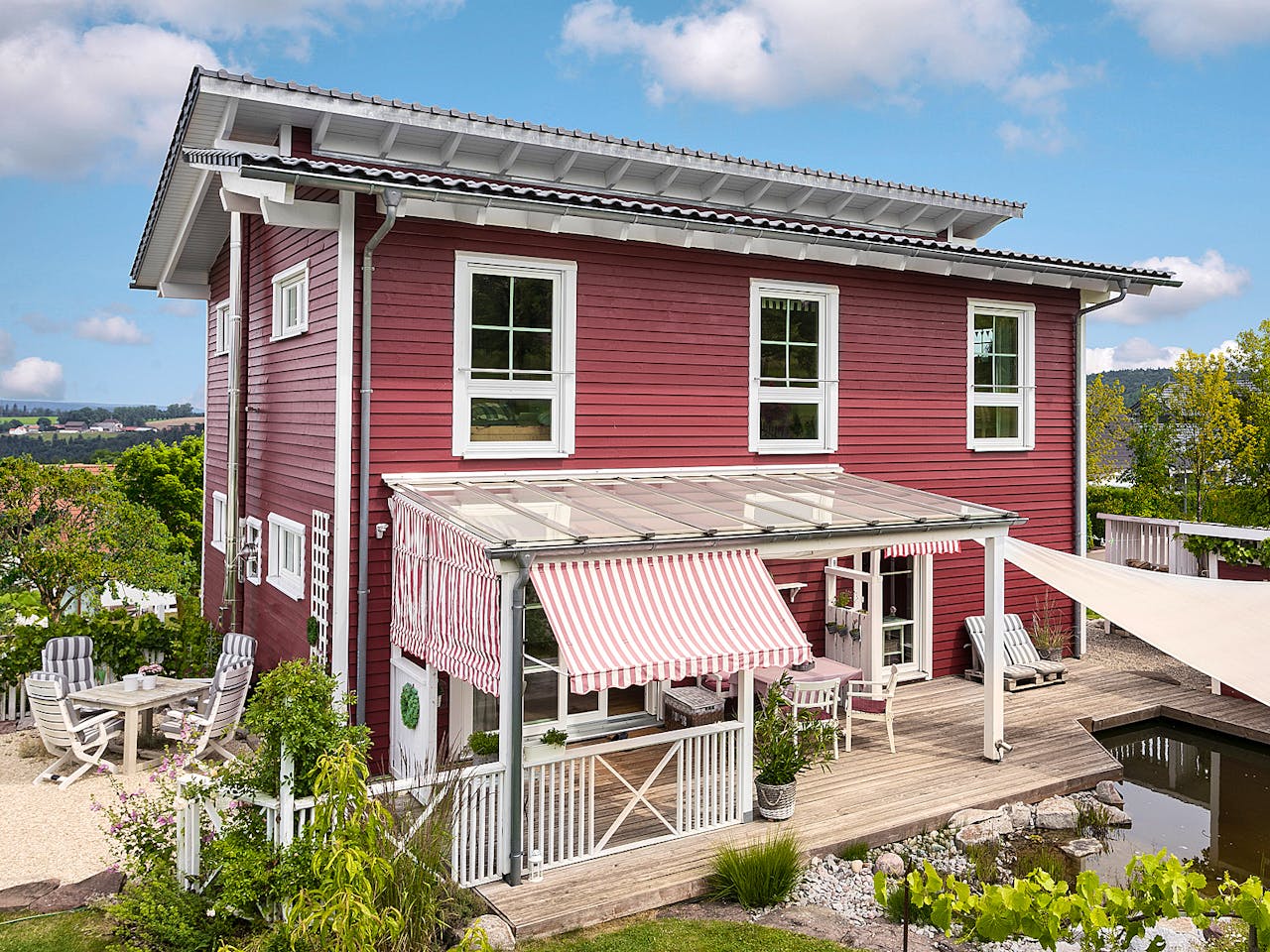 Fertighaus E 20-168.1 - Fertighaus im skandinavischen Landhausstil & Hampton-Flair von SchwörerHaus, Außenansicht 1