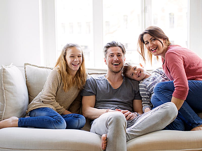 Familie sitzt auf einem Sofa